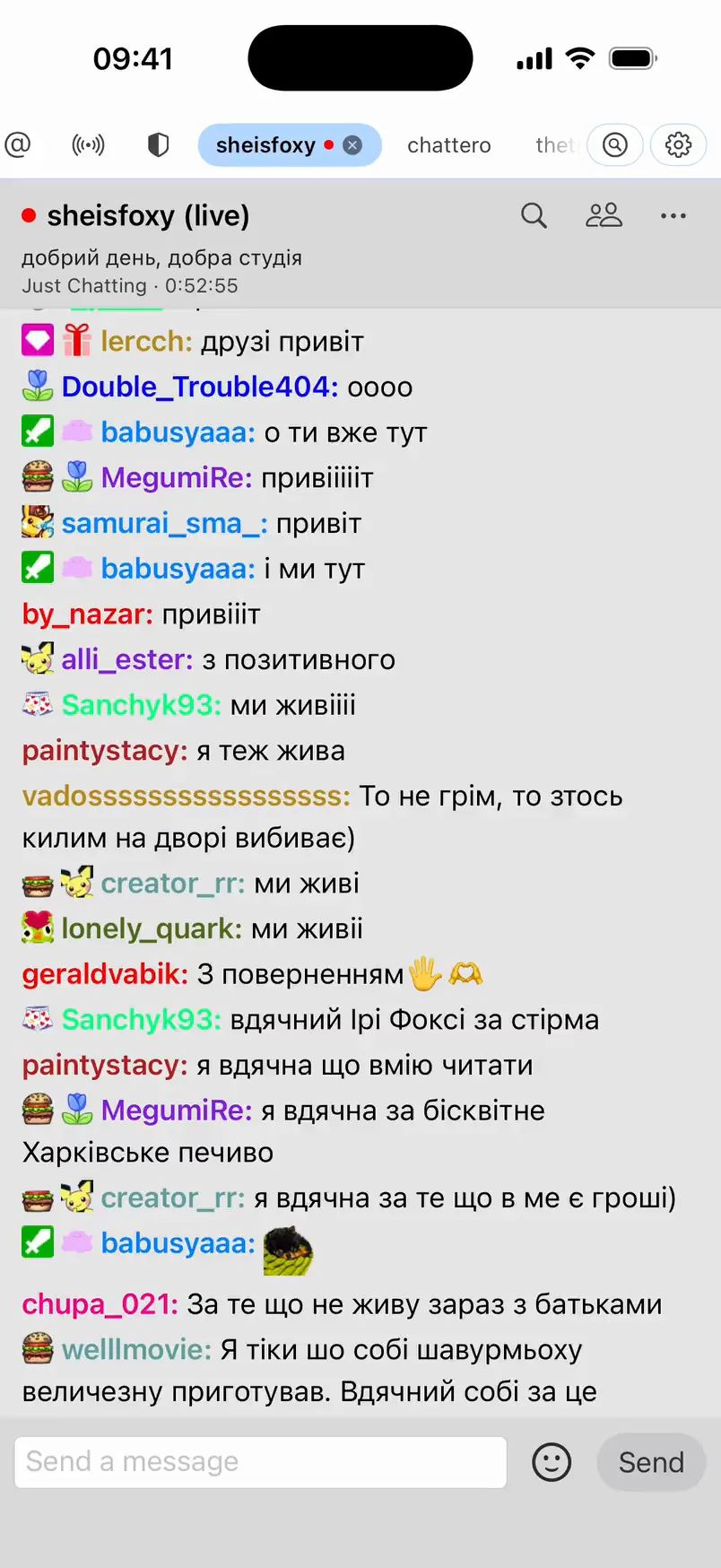 Chattero in the light theme showing the sheisfoxy channel live: stream title, category and uptime in the header, and viewers saying hello with badges and emotes.